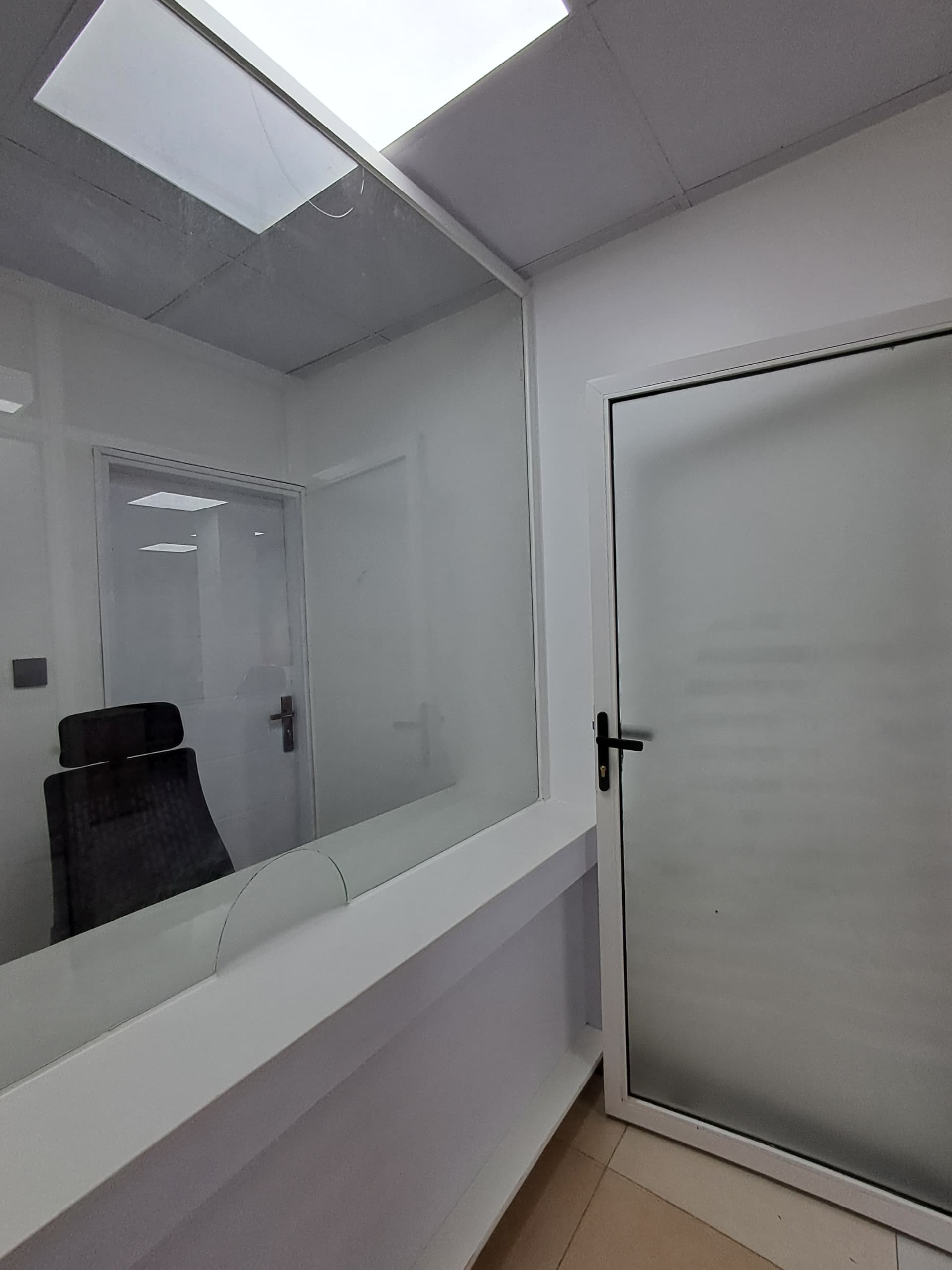 Completed office interior with glass partitioning and integrated ceiling