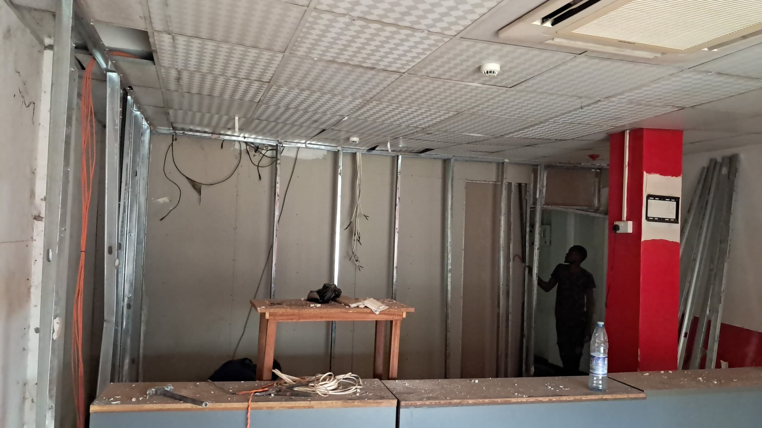 Ceiling grid installation during a fit-out, built to a ceiling plan