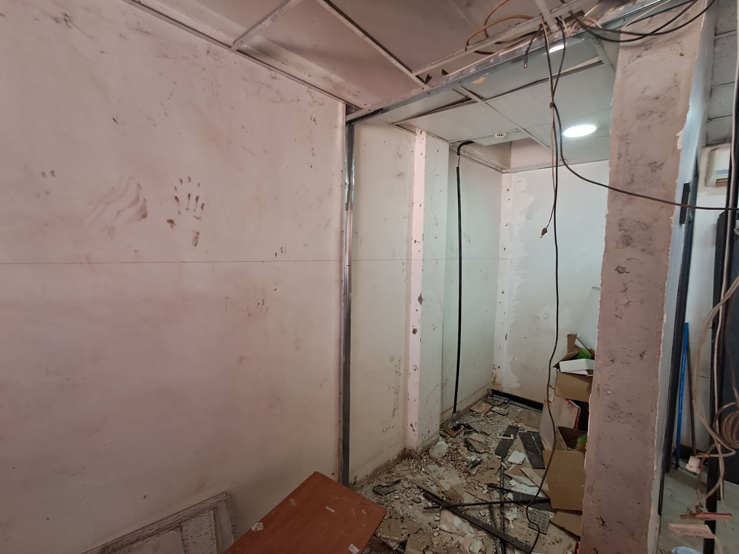 Corridor strip-out during an office fit-out, before new work begins